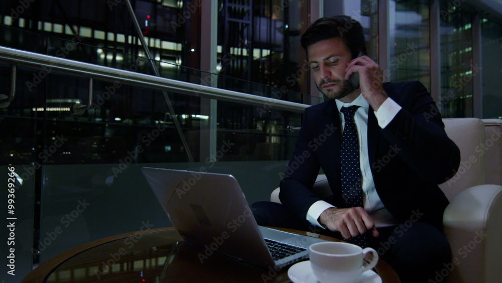 Arabic business man UAE real estate night office technology laptop smart phone Arabic business man UAE real estate night office technology laptop smart phone