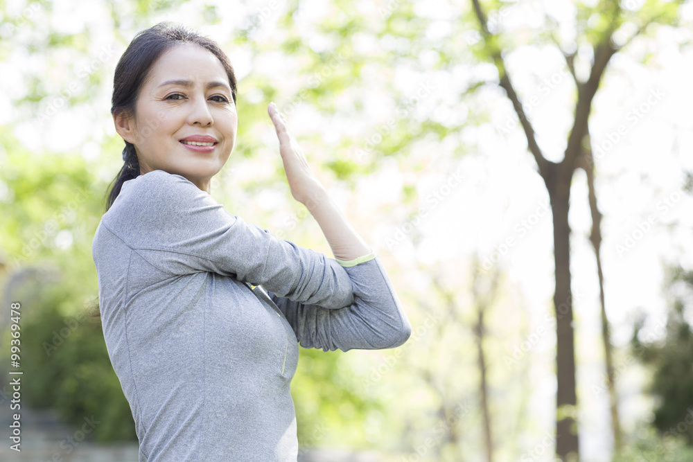 Happy mature woman exercising in park Happy mature woman exercising in park