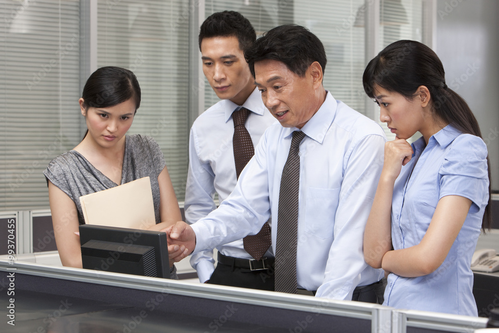 Senior Colleague Helping Co-workers Senior Colleague Helping Co-workers