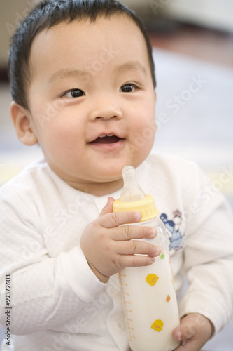 Infant with milk bottle