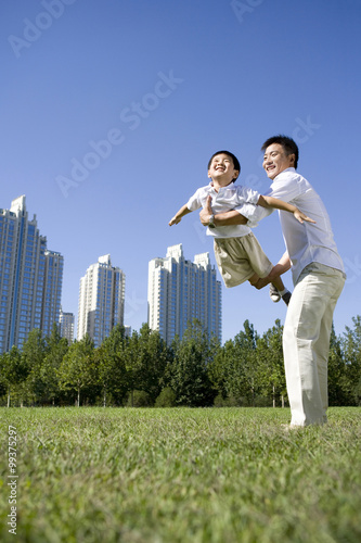 Father and son playing in the park