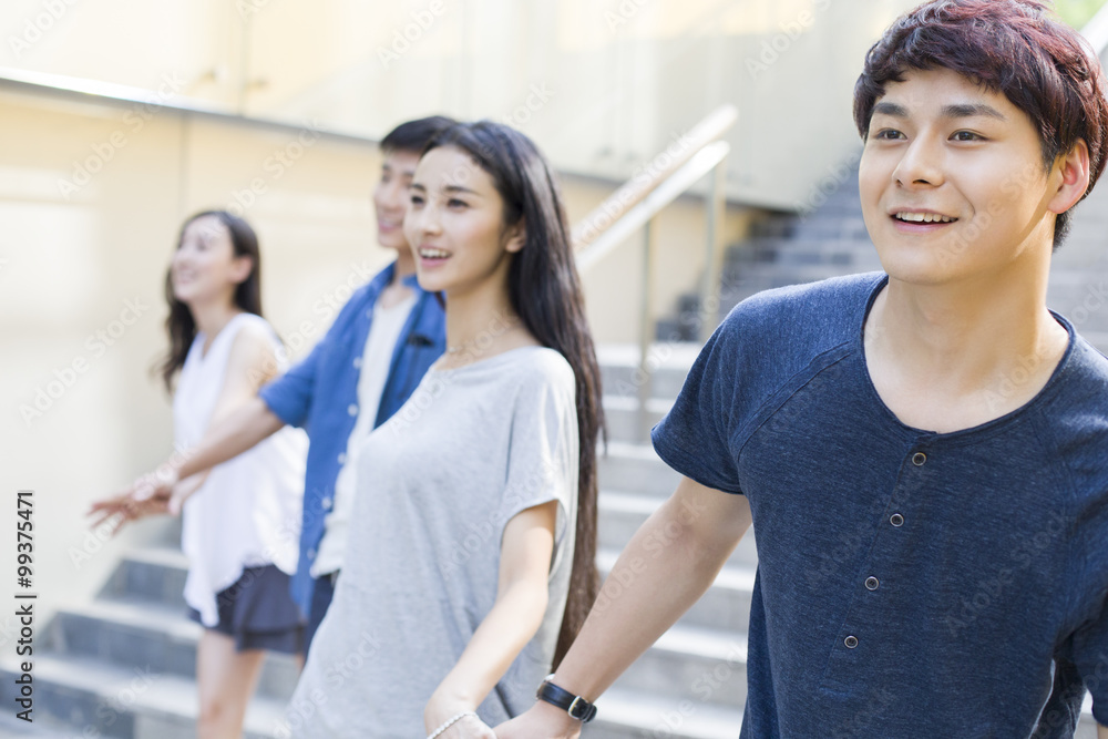 Young man holding hands with his girlfriend Young man holding hands with his girlfriend
