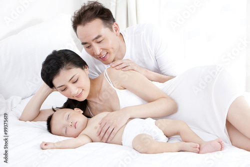 Young parents watching cute baby sleeping