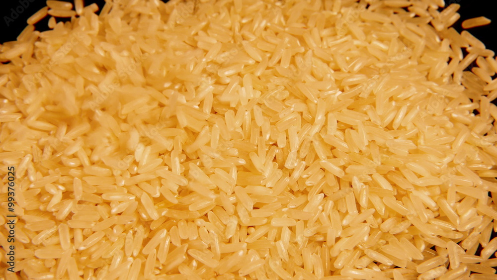 Dry raw rice paddy cereal grains pour and spin slowly. 4K UHD video footage. Dry raw rice paddy cereal grains pour and spin slowly. 4K UHD video footage.