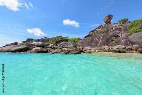 Beautiful landscape people on rock is a symbol of Similan Islands, blue sky and cloud over the sea during summer at Mu Ko Similan National Park, Phang Nga province, Thailand