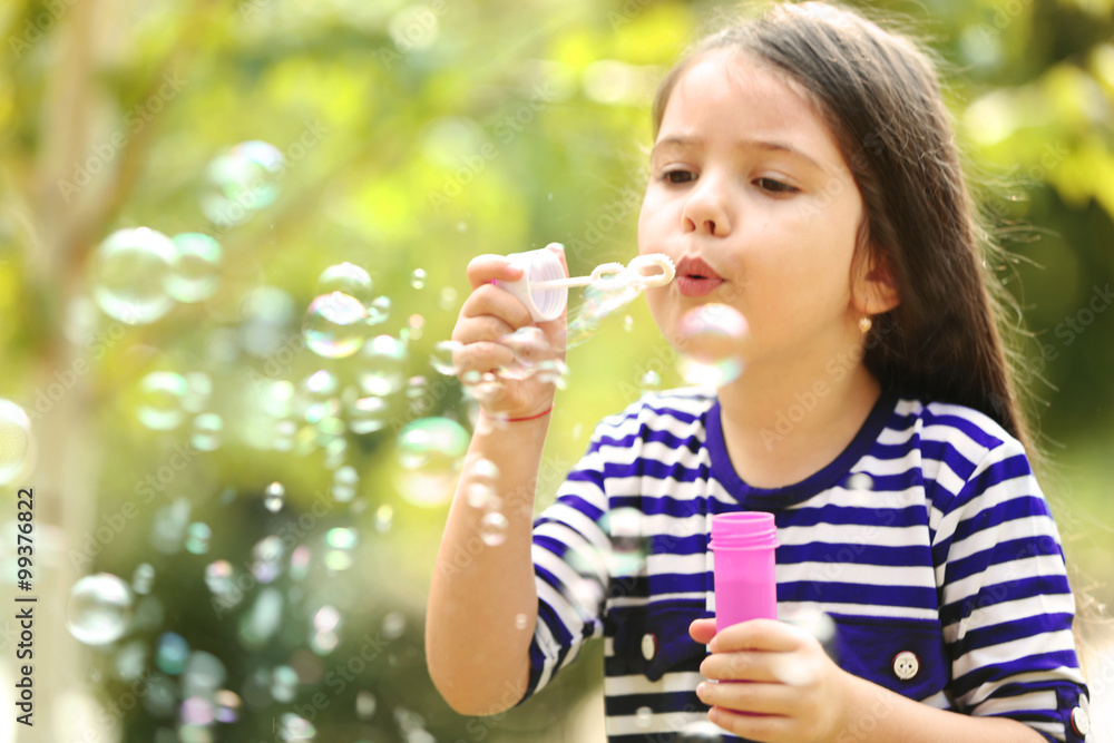 Happy little girl with bubbles in the park Happy little girl with bubbles in the park
