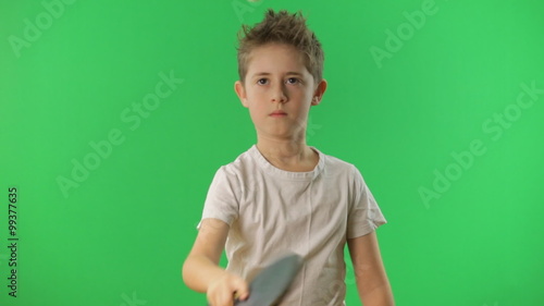 Kid juggles the ping pong ball. Green screen 