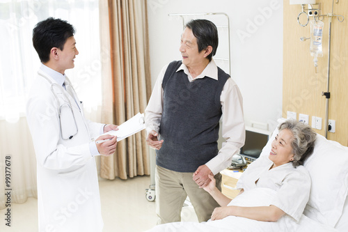 Doctor with senior couple in hospital