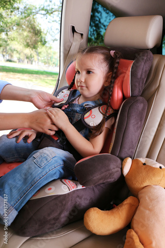 Cute little girl sitting in...
