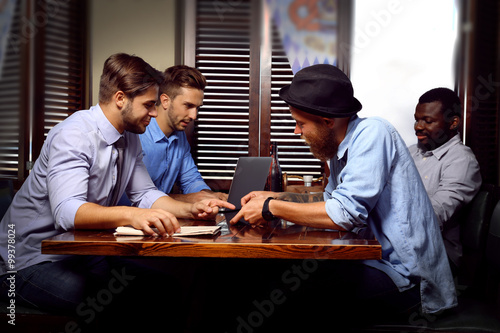 Young men talking in cafe
