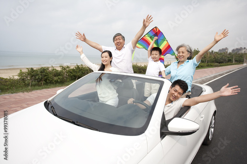Happy Family Driving in a Convertible