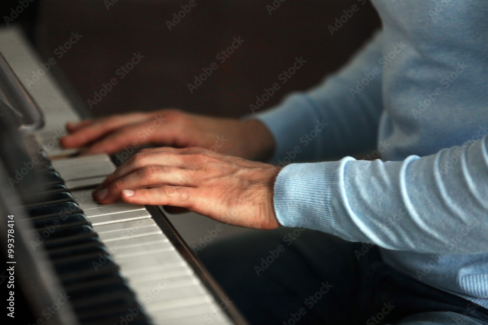 Close up of man hands piano playing