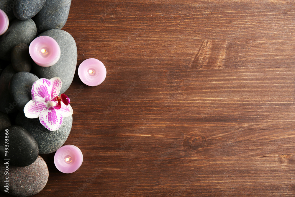 Spa stones and orchid on wooden background Spa stones and orchid on wooden background