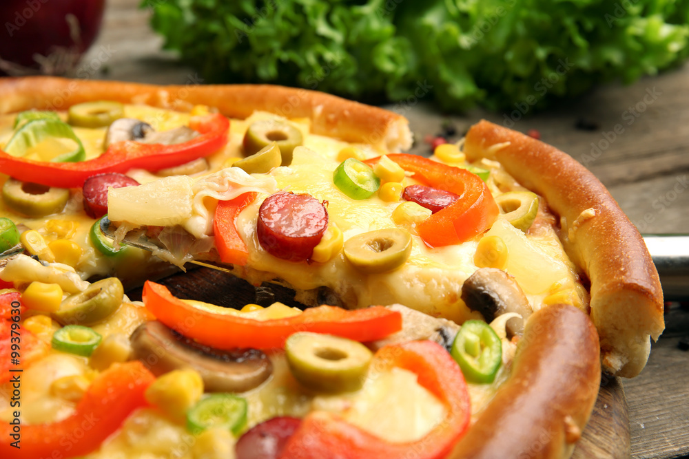 Delicious pizza with vegetables and slice on shovel, close-up Delicious pizza with vegetables and slice on shovel, close-up