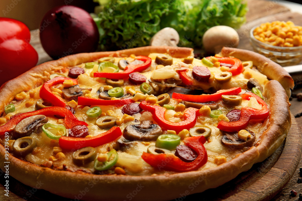Delicious pizza with vegetables and slice on shovel, close-up Delicious pizza with vegetables and slice on shovel, close-up