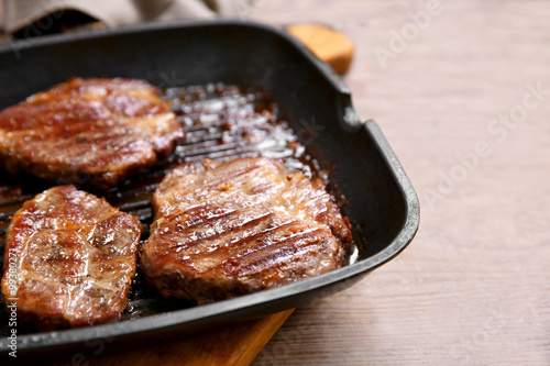 Roasted beef fillet on pan, on wooden background