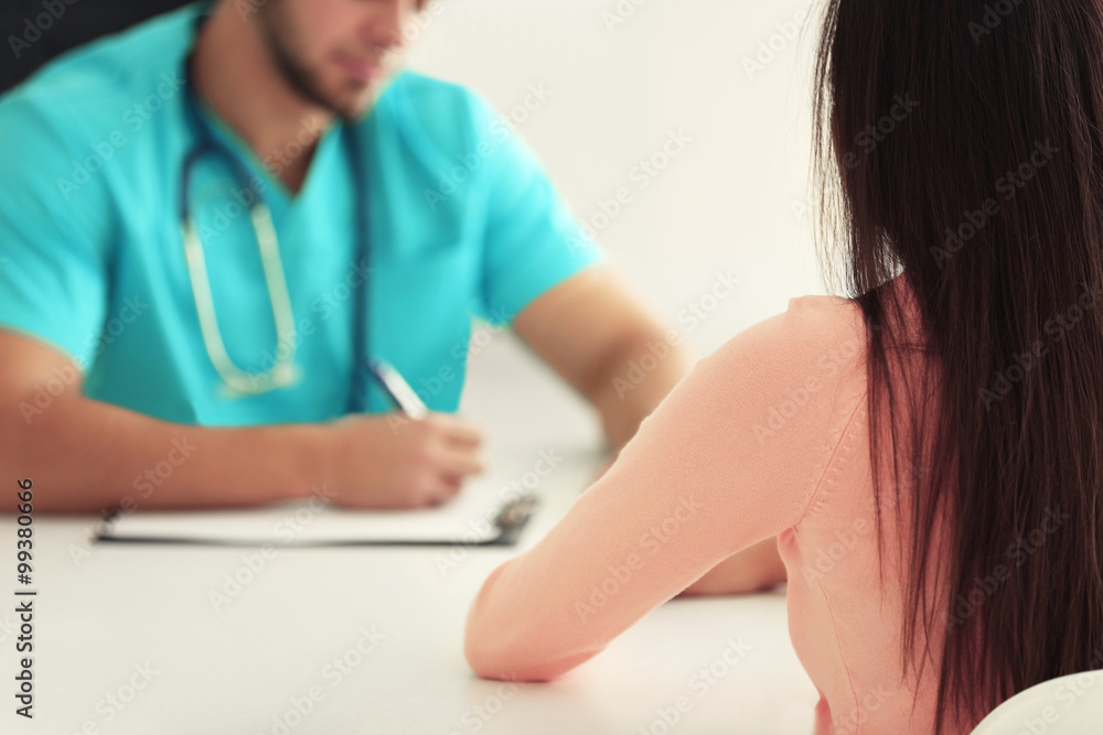 Female patient visiting doctor on light background Female patient visiting doctor on light background