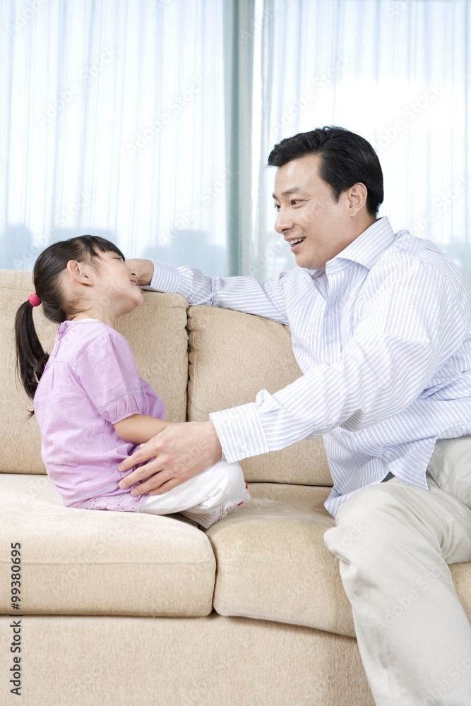 Girl and father on couch Girl and father on couch