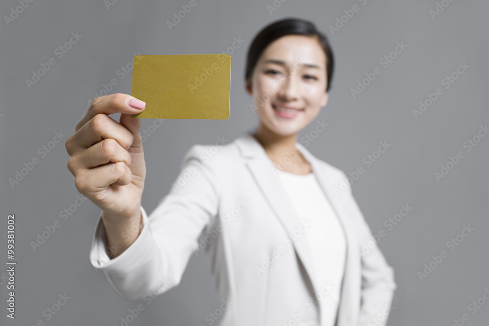 Happy young businesswoman holding a credit card Happy young businesswoman holding a credit card