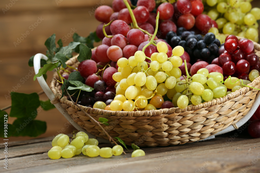 Grape in basket on wooden table Grape in basket on wooden table