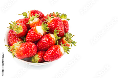 Plateful of freshly harvested organic strawberries with white background