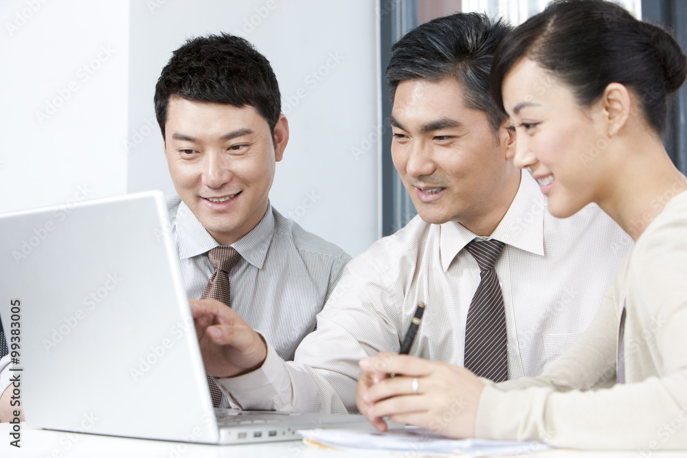 Business Executive Explaining to Younger Businesspeople Business Executive Explaining to Younger Businesspeople