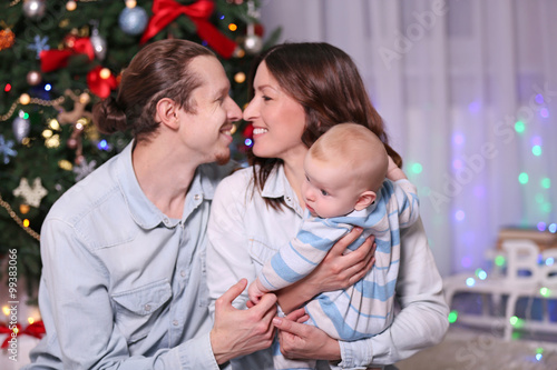 Happy young family with inf...