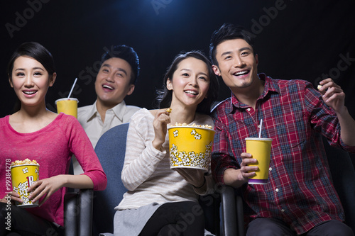 Young couple watching movie in cinema photo