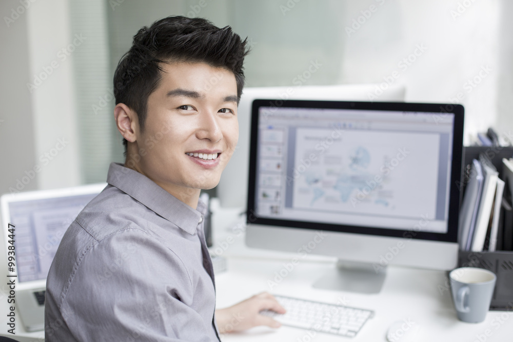Young businessman using computer in office Young businessman using computer in office