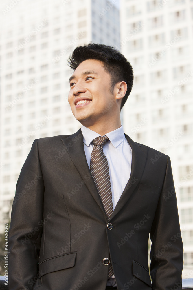 Portrait of happy young businessman in downtown district Portrait of happy young businessman in downtown district