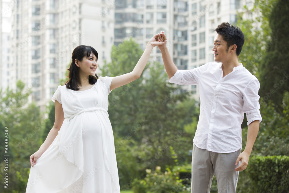 Pregnant woman dancing with husband Pregnant woman dancing with husband