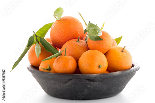 Tangerines on clay bowl