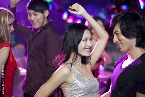 Stylish young people dancing in nightclub