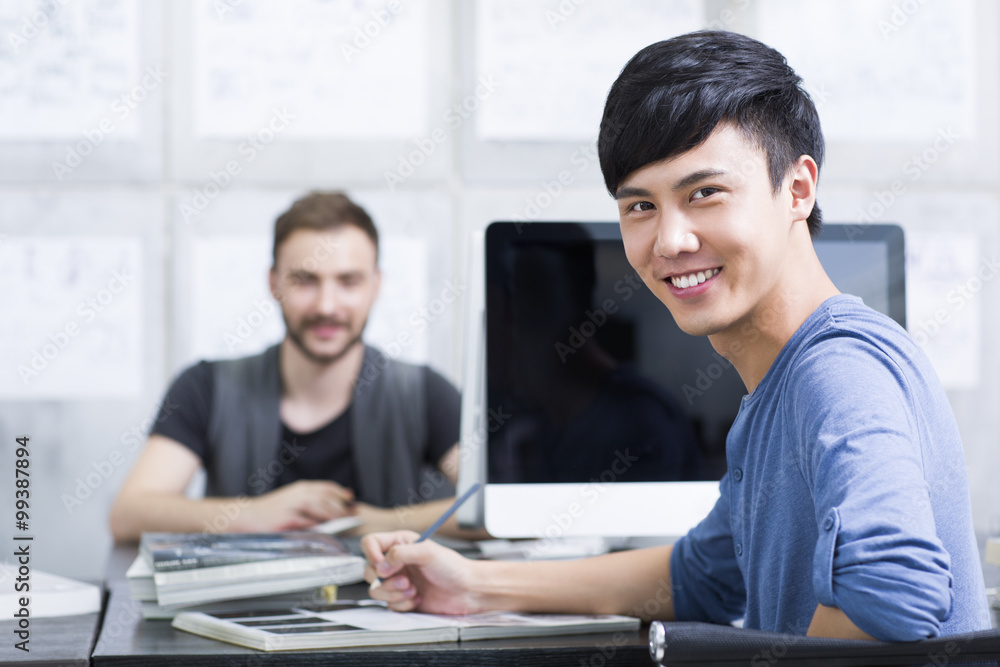 Young man with colleague in office Young man with colleague in office