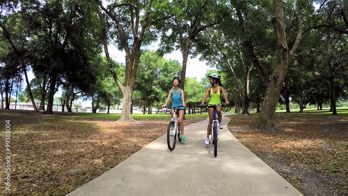 Wallpaper Mural Young multi ethnic fitness girls enjoying riding bikes outdoor Torontodigital.ca