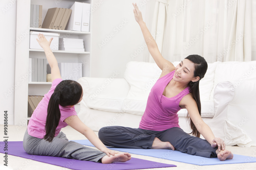 Monther and daughter doing yoga Monther and daughter doing yoga
