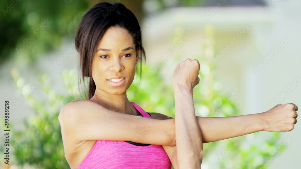 Young fitness African American woman enjoying stretching outdoors Young fitness African American woman enjoying stretching outdoors