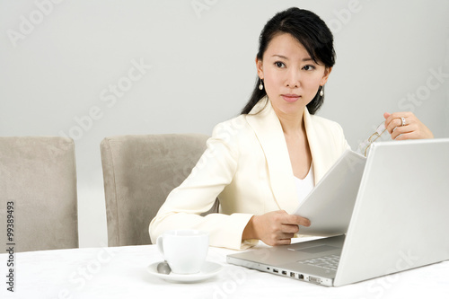 Businesswoman Using Laptop At Dinner Table