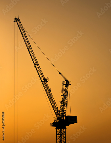Silhouette of tower crane for construction site at sunset