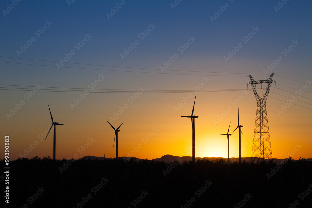 Electricity pylon and windmills in Inner Mongolia province, China Electricity pylon and windmills in Inner Mongolia province, China