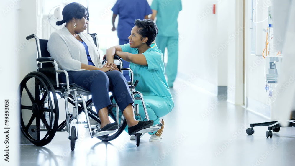 Multi ethnic team and nurse with senior patient on wheelchair in medical center Multi ethnic team and nurse with senior patient on wheelchair in medical center
