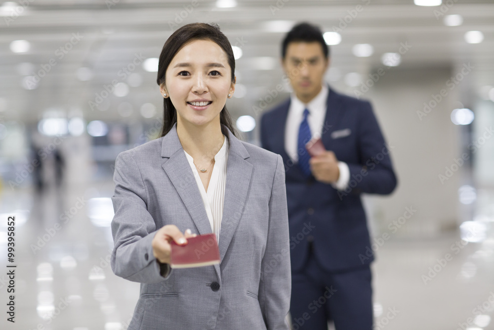 Young businesswoman showing her passport in airport