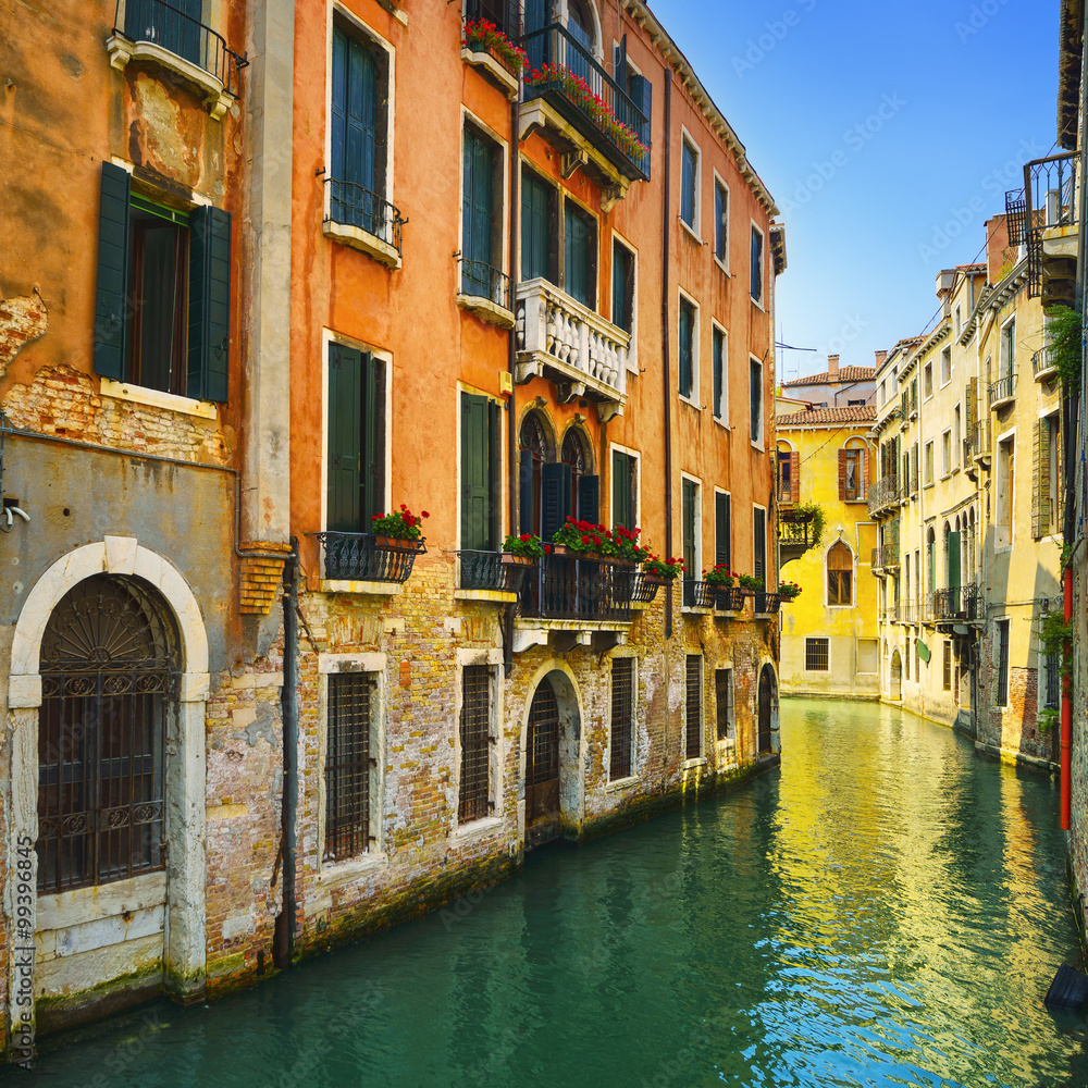 Venice sunset in water canal and traditional buildings. Italy