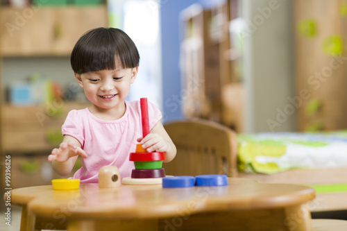 Cute girl playing with toys at home