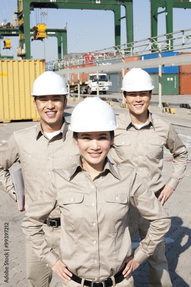 shipping industry workers with hands on their hips shipping industry workers with hands on their hips