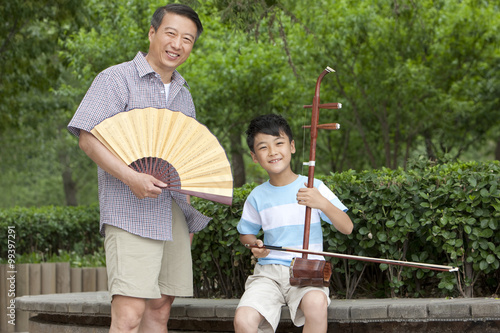 Grandfather teaching grandson Chinese traditional Erhu 
