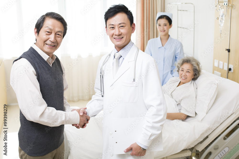 Senior couple shaking hands with doctor in hospital Senior couple shaking hands with doctor in hospital