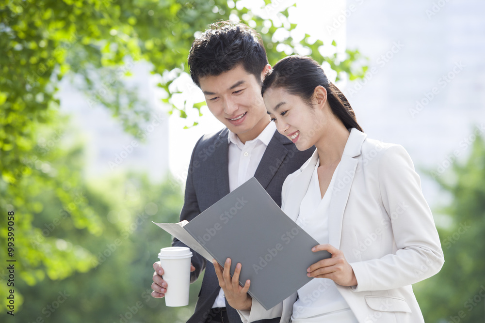 Young business person working with coffee outdoors Young business person working with coffee outdoors