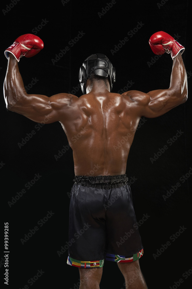 Rear View Of Boxer Flexing Muscles