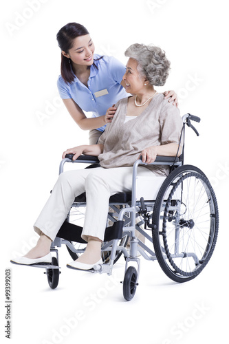 Female nursing assistant taking care of senior in wheelchair © Blue Jean Images